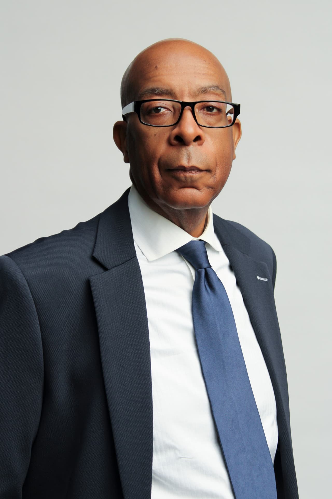 Michael Wimberley, founder of Detroit Intelligence, in a navy suit and blue tie